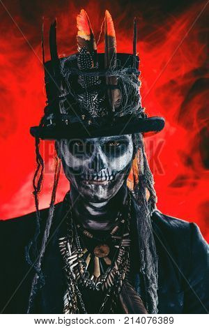 A man with a skull makeup dressed in a tail-coat and a top-hat. Baron Saturday. Baron Samedi. Dia de los muertos. Day of The Dead. Halloween.
