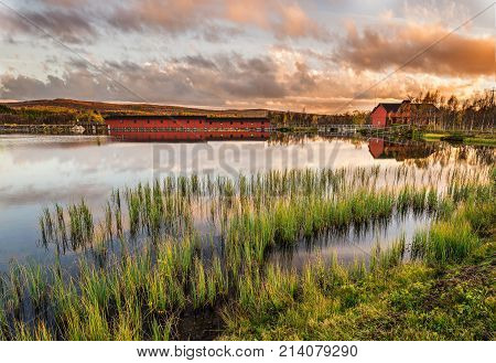 Iconic wooden bridge on Narsjoen lake in Hedmark county, Norway at sunset.