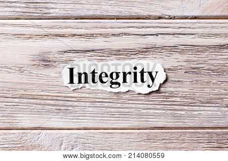 Integrity of the word on paper. concept. Words of Integrity on a wooden background.