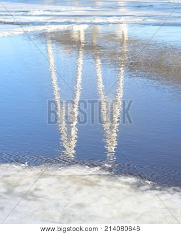 Reflection of cable stayed bridge on the outskirts of St. Petersburg at sunny winter day Russia.