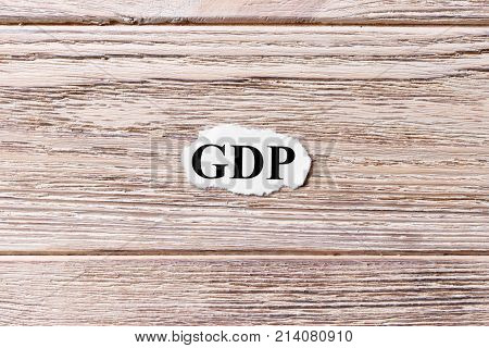 GDP of the word on paper. Gross Domestic Product concept. Words of GDP on a wooden background.