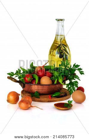 Menemen. close-up still life with mixed vegetables in frypan eggs and olive oil and tomato paste isolated on white background