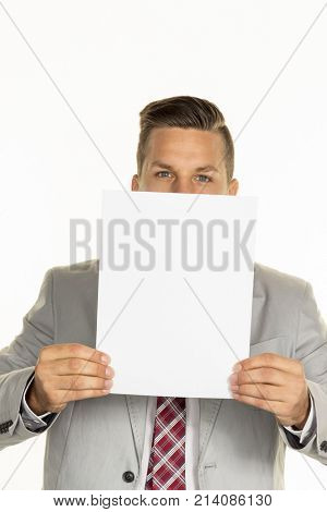 manager holds blank sheet in front of face