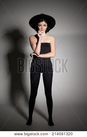 Stylish Big Black Hat and Black Stockings. Skinny Sexy Model.