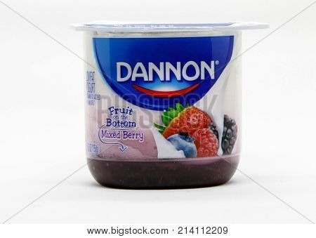 New York November 10 2017: Dannon mixed berry fruit on the bottom yogurt stands against white background.