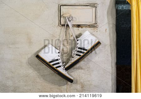 White Adidas Sneakers Hang On Laces