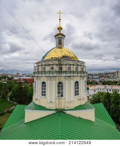 Gilded dome of Russian Orthodox church. St.Mikhail Arcangel church in Orel Russia with cloudy sky