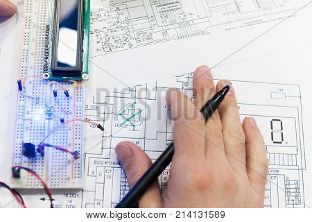 Paperwork electro scheme mechatronics breadboard concept. Robotics creation with microcontroller. Student experiment.