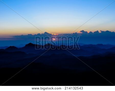 Sunrise in the holy summit of Mount Sinai, Aka Jebel Musa, 2285 meters, in Sinai Peninsula in Egypt. Copy space.