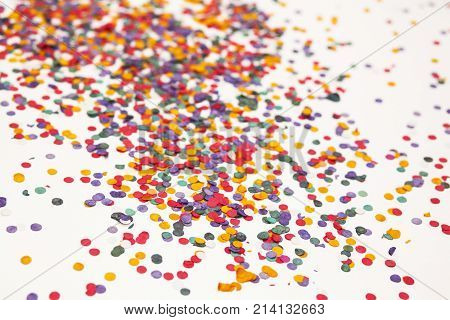 Colorful confetti over white background. Christmas or birthday concept