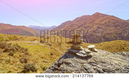 Stack of stones covered with moss on top of the mountain
