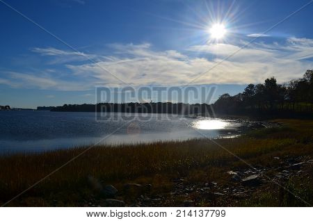 Captivating view of the ocean and the large sun with its rays