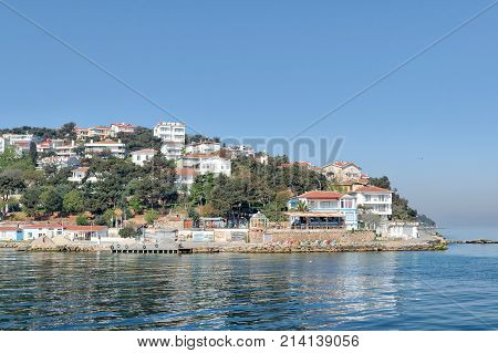 View of Burgazada island from the sea with summer houses. The island is the third largest one of four islands named Princes' Islands in the Sea of Marmara near Istanbul Turkey