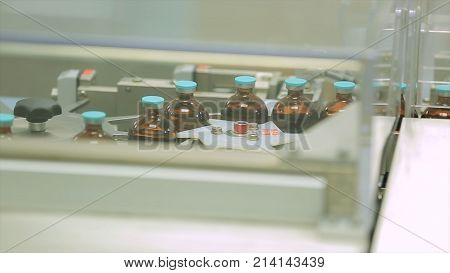 Pharmaceutical industry. Production line machine conveyor at factory with bottles. pharmaceutical production of liquid pharmaceuticals HD