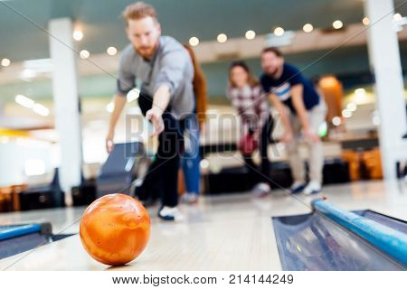 Friends having fun while bowling and speding time together
