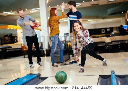 Friends having fun while bowling and speding time together