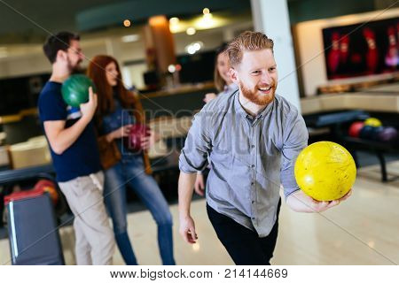 Friends having fun while bowling and speding time together