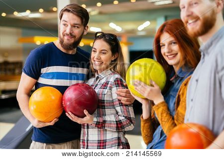 Friends having fun while bowling and speding time together