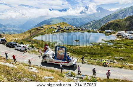Col de la Croix de Fer France - 25 July 2015: Le Gaulois caravan driving on the road to the Col de la Croix de Fer in Alps during the stage 20 of Le Tour de France 2015. Le Gaulois is an important French producer of poultry meat products.