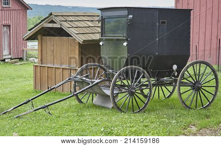 amish buggy parked in barnyard of Amish Farm