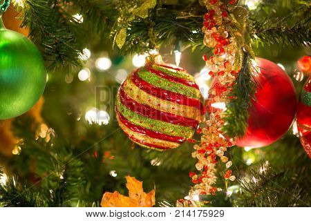 Multi Colorred Glitter Ball Ornament Hanging On Christmas Tree With Selective Focus