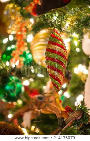 Diamond Shaped Ornaments Hang On Christmas Tree In Selective Focus Of Bokeh Background