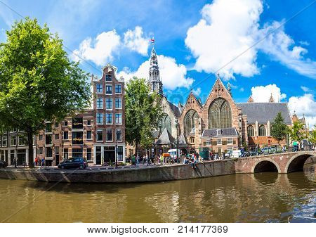 Oude Kerk (old Church) And Voorburgwal Canal In Amsterdam In A Summer Day