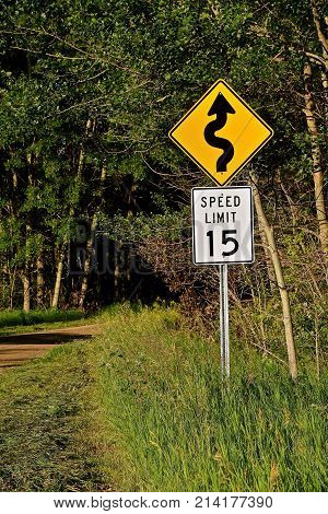 Speed limit sign on a rural winding gravel road in the country