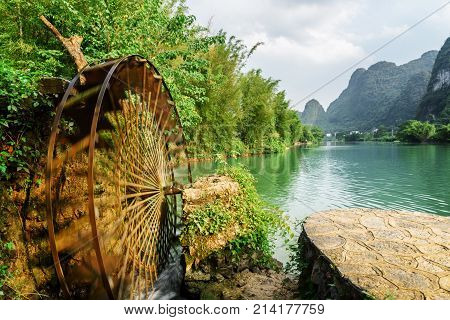 Moving Water Wheel (noria) On The Yulong River, Guilin, China