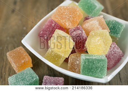 Tasty marmalade candies with different colors, close up