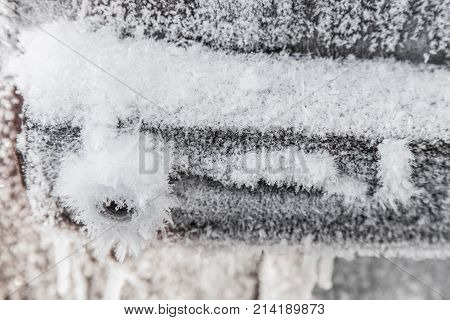 Detail of old wooden door covered hoarfrost closeup
