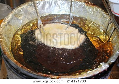 Pancake Fried In The Pot Of Hot Oil In The Stall