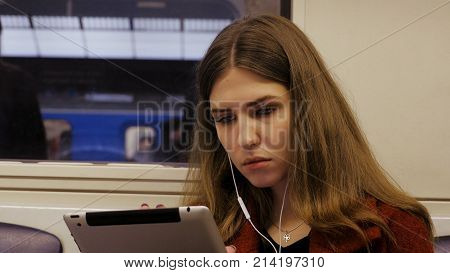 Young Businesswoman Traveling Train Tablet Computer. Young Woman In Subway Works In The Tablet.