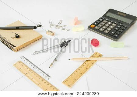 Close up of white office desk with various supplies and items. Workplace office education accounting concept