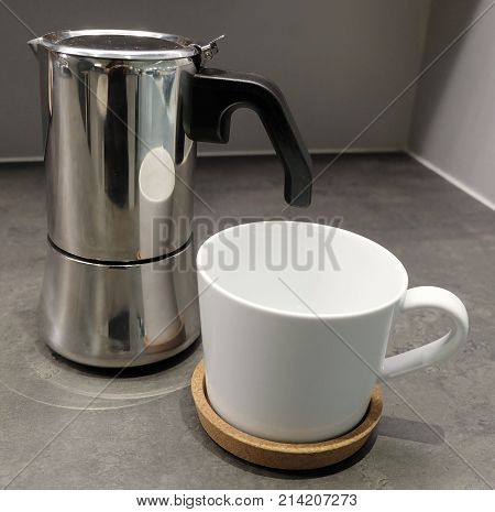 Cuisine and Food White Porcelain Cup with Coffee Pot on The Table Used for Preparing and Drinking Coffee in The Morning.