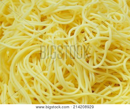 Cuisine and Food Golden Pile of Yellow Egg Noodles for Asian Cooking Background.