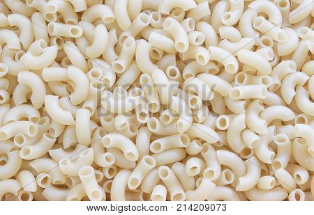 Food and Cuisine Background Textured of Uncooked and Dried Elbow Macaroni or Gomiti Pasta.