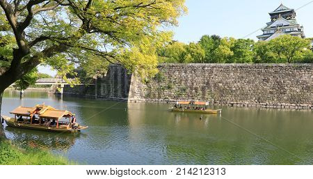 Touristic boats with tourists along the moat of Osaka Castle one of best activities you can experience around Osaka Castle area, one of most famous landmarks of Japan