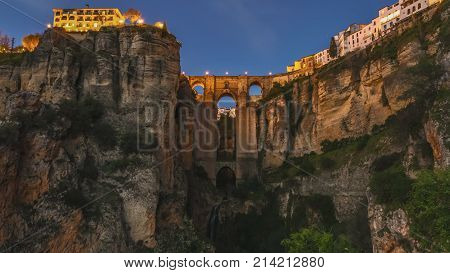 Day and dusk to night   of the popular historic landmark of spectacular Puente Nuevo, New Bridge at sunset, over Guadalevin River in Ronda town, Andalusia, Spain.