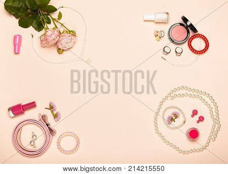 Fashionable Women's Cosmetics and Accessories. Falt Lay. Nail Polish and blush. Jewelry and Rings. A bouquet of flowers. Pink roses