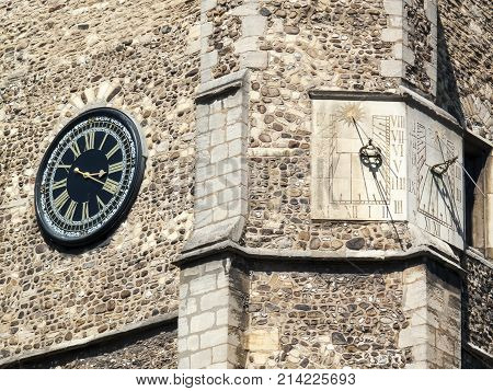 Cambridge, UK, May 31 2009 :  Ancient sundials and clock of St Botolph's Parish Church in the city centre which was built around 1350 and dedicated to the patron saint of travellers