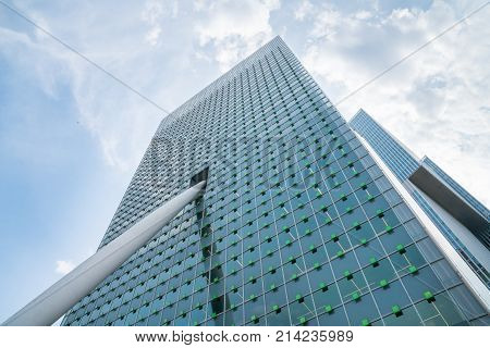 ROTTERDAM HOLLAND - AUGUST 24 2017; Architecture from street below KPN Telecom Building facade with green small square decorations towering toward sky