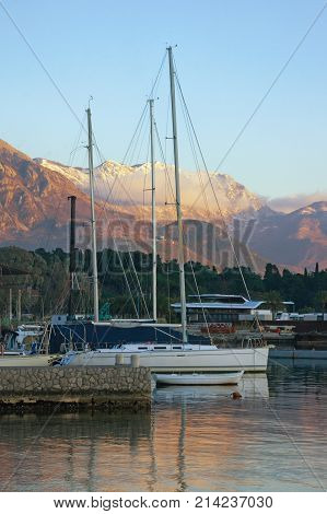 Mediterranean winter evening. View of the snow-capped mountain of Lovcen from the port in Tivat, Montenegro