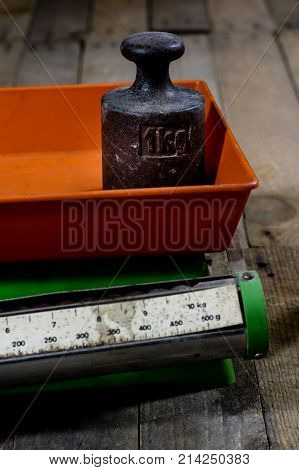 Old Weight And Weights On A Wooden Table. Old Used Kitchen Scale With Old Scale And Kilogram Weight