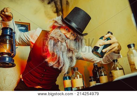Bearded Man Wearing Black Hat And Vest With The Lantern. Medicine Man In Dickens Style.