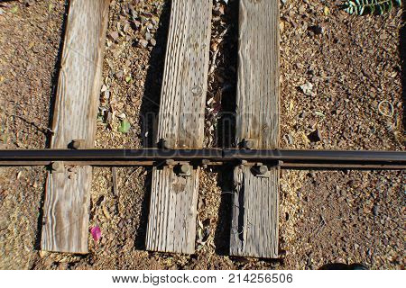 3 rail road ties with one rail small gauge weathered