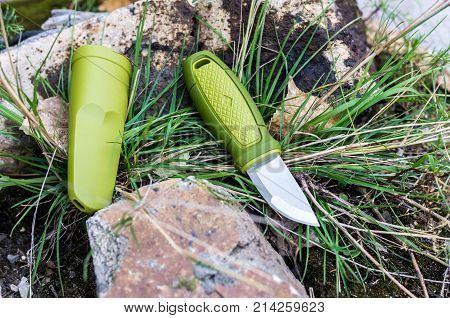 A Knife With A Green Handle. Knife And Plastic Sheath.