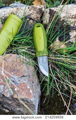 A Knife With A Green Handle. Knife And Plastic Sheath. Vertical Shot.