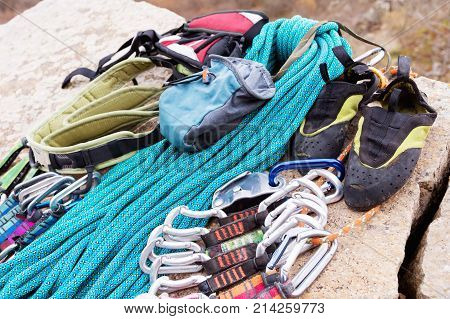Climbing equipment - bag for magnesia rope and carbines view from the side close-up. A rocks and mountains on background. Concept of outdoor sport