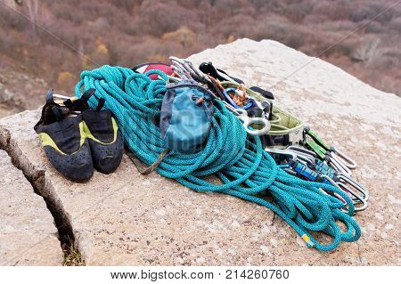 Climbing equipment - bag for magnesia rope and carbines view from the side close-up. A rocks and mountains on background. Concept of outdoor sport